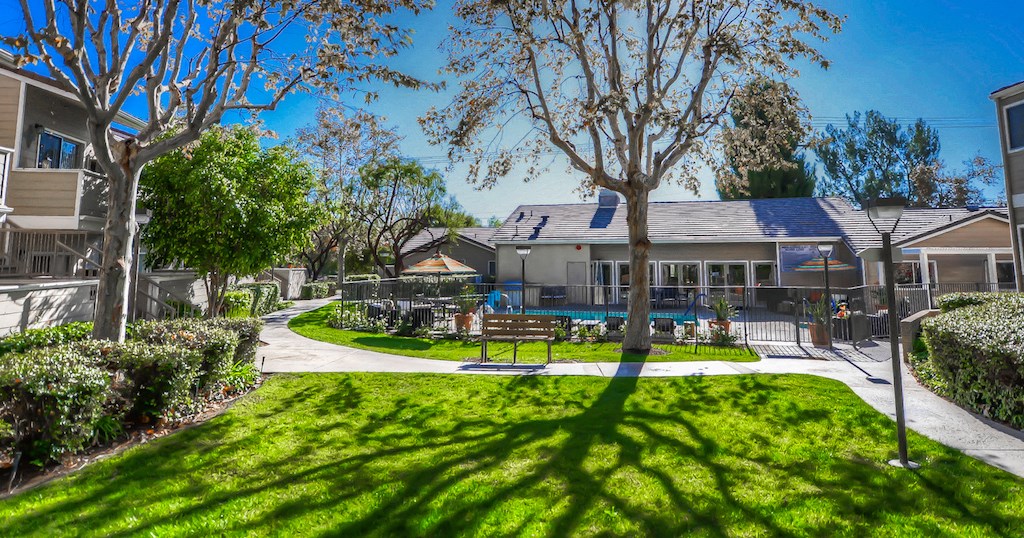 the backyard of a house with a pool and a yard