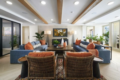 a living room with couches and chairs and a table