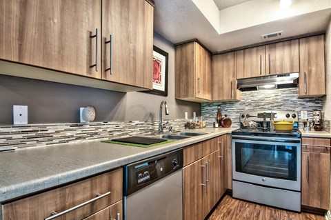 A modern kitchen with wooden cabinets and stainless steel appliances.