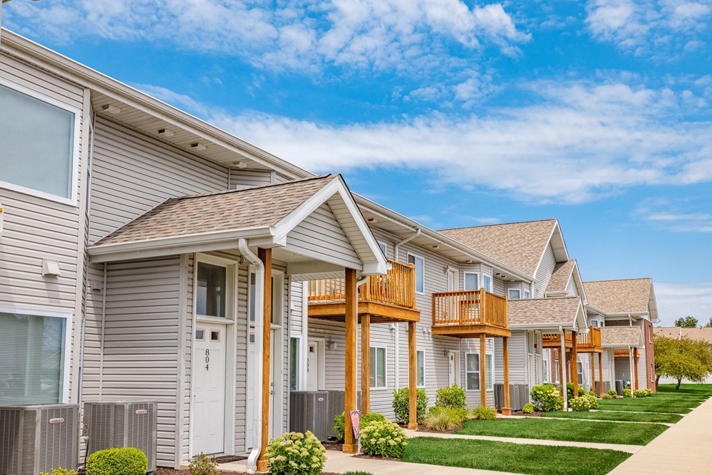 a row of houses with a sidewalk in front of them