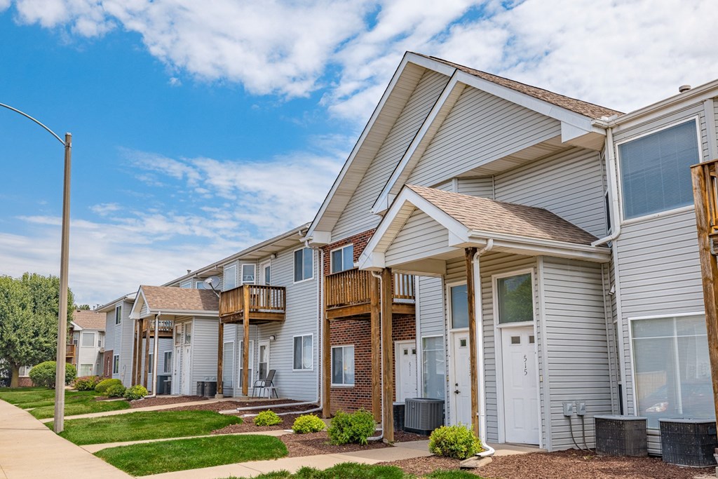 a row of houses with a sidewalk in front of them