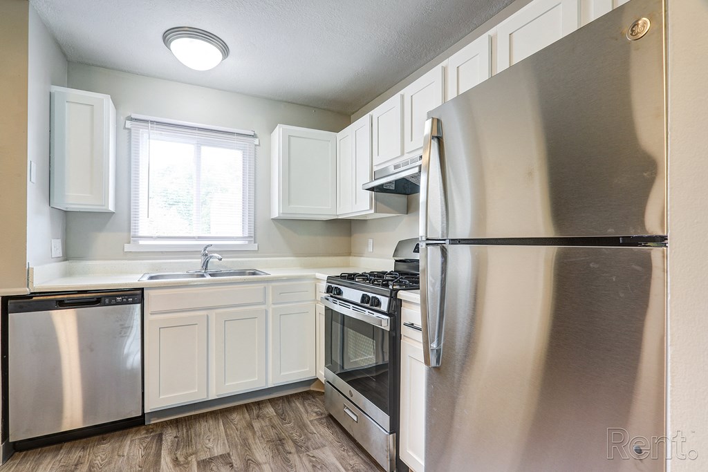 A modern kitchen with a stainless steel refrigerator.