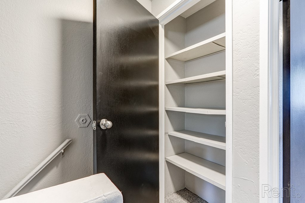 A black door with a silver handle and a white door to the right.