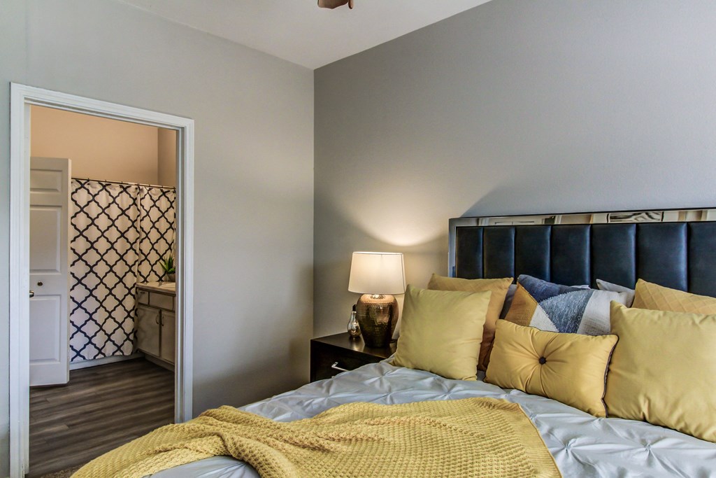 a bedroom with a bed and a door to a bathroom