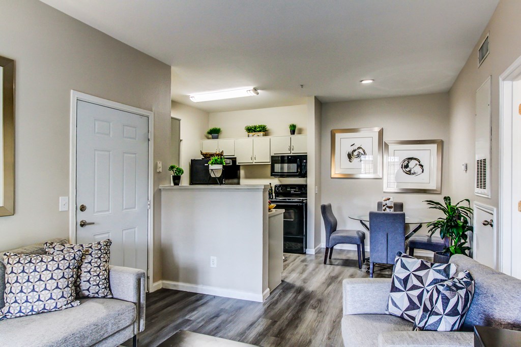 a living room and kitchen with a couch and a table