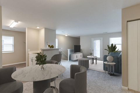 A living room with a grey sofa, a white table and a television.