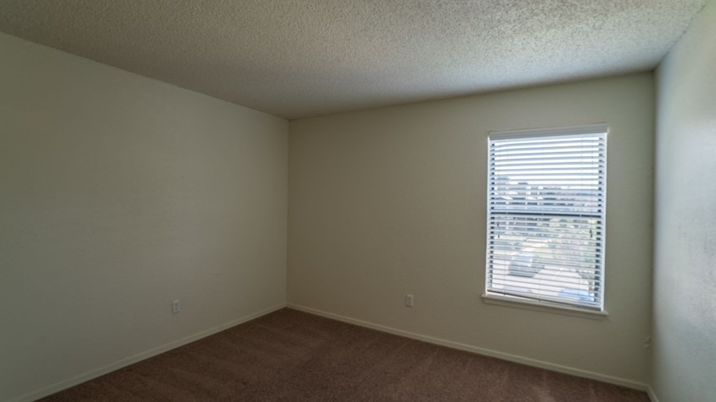 the living room of an empty house with a window