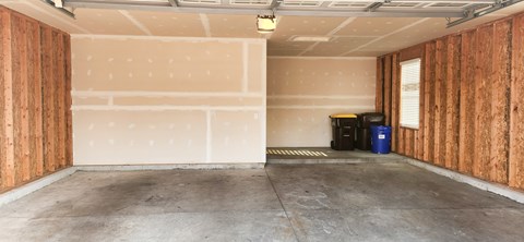 A room with wooden walls and a concrete floor.