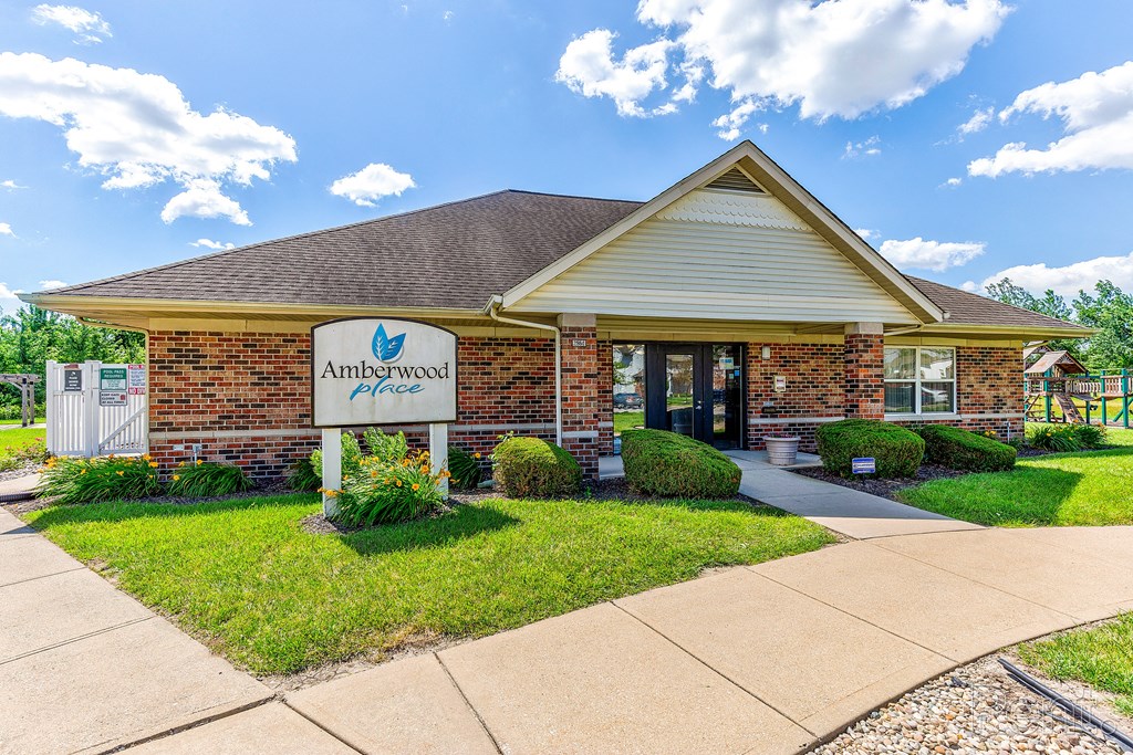 a brick building with a sign out front of an office