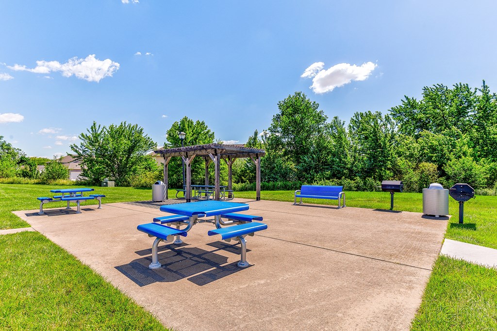 a picnic area with benches and a gazebo