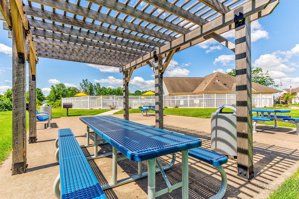 a picnic area with a table and benches