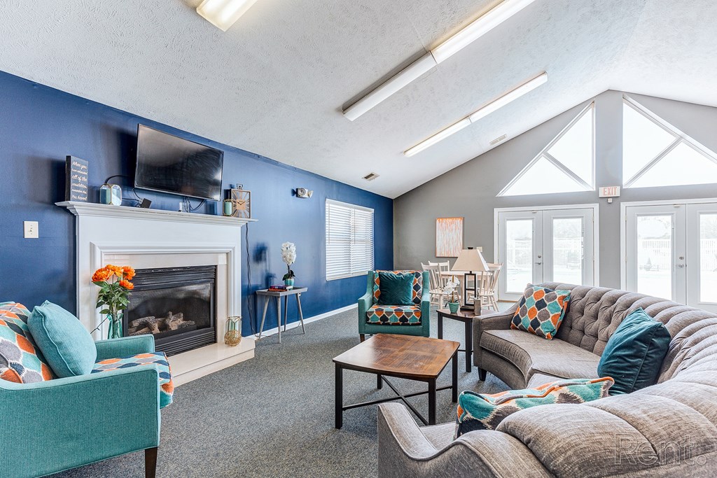 a living room with couches and chairs and a fireplace