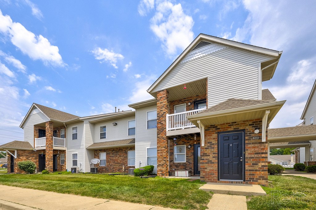 the view of an apartment building with a blue door