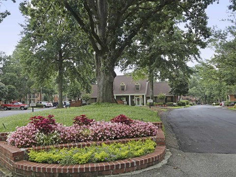 a flower garden in front of a house