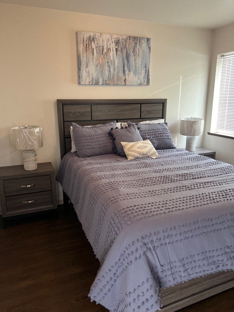 a bedroom with a bed and two night stands