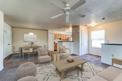 A living room with a dining table and chairs.