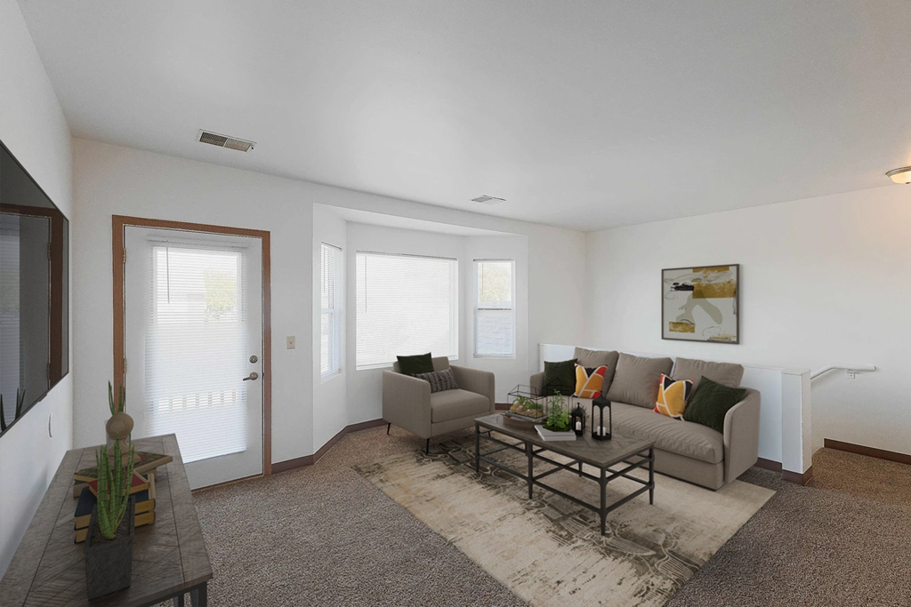 A living room with a grey couch and a coffee table.