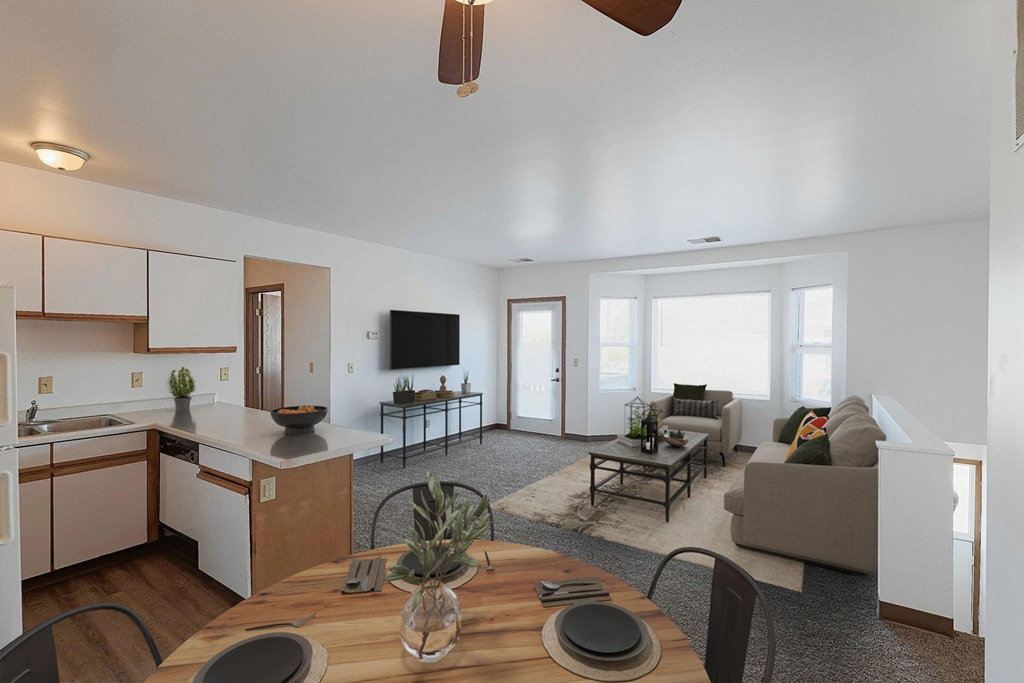 A modern kitchen with a dining table set for two.