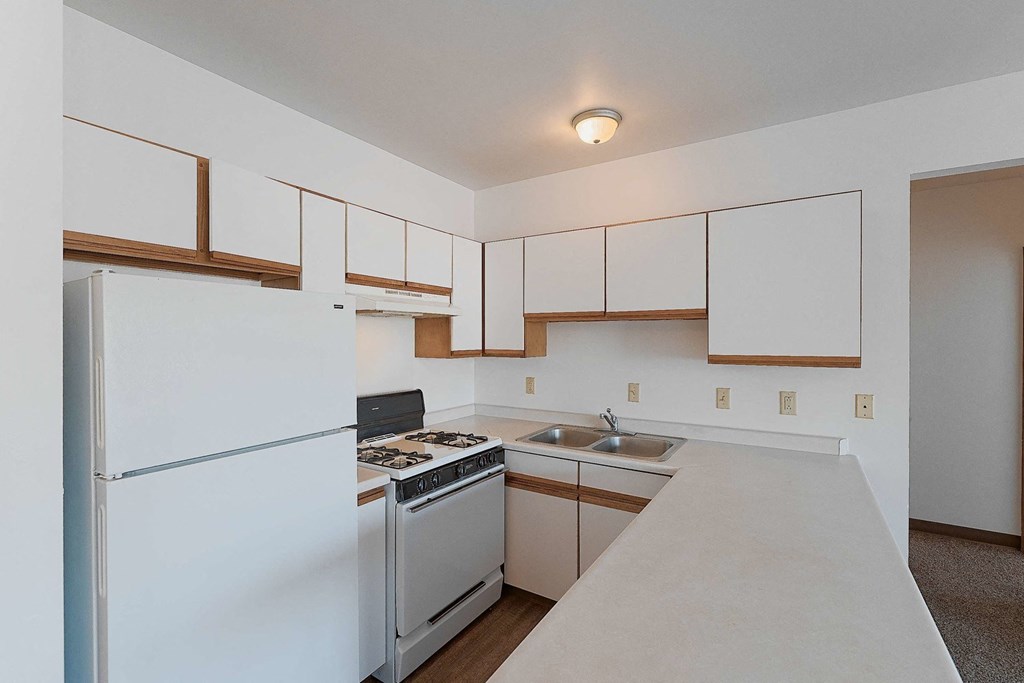 a kitchen with white appliances and white cabinets