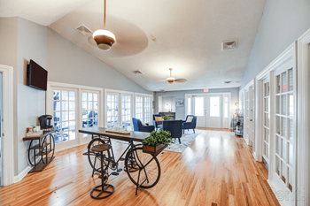 a living room with a table with bikes in the middle of it