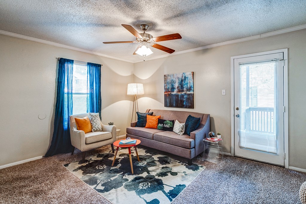 a living room with a couch and a ceiling fan