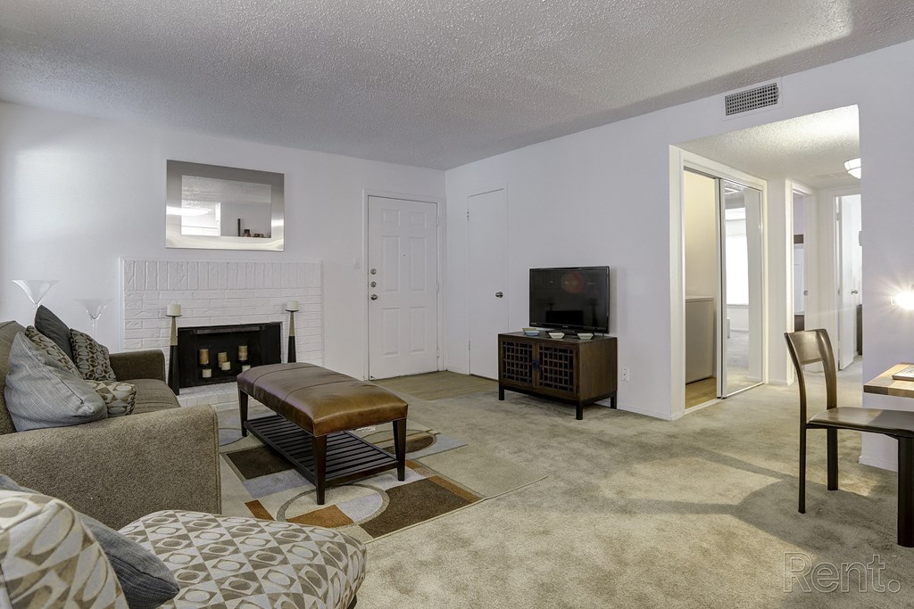 a living room with a couch and a chair and a fireplace