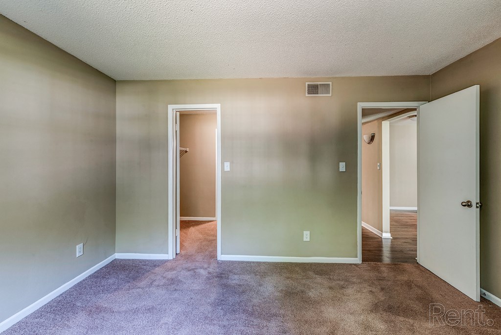 an empty living room with white walls and a carpeted floor