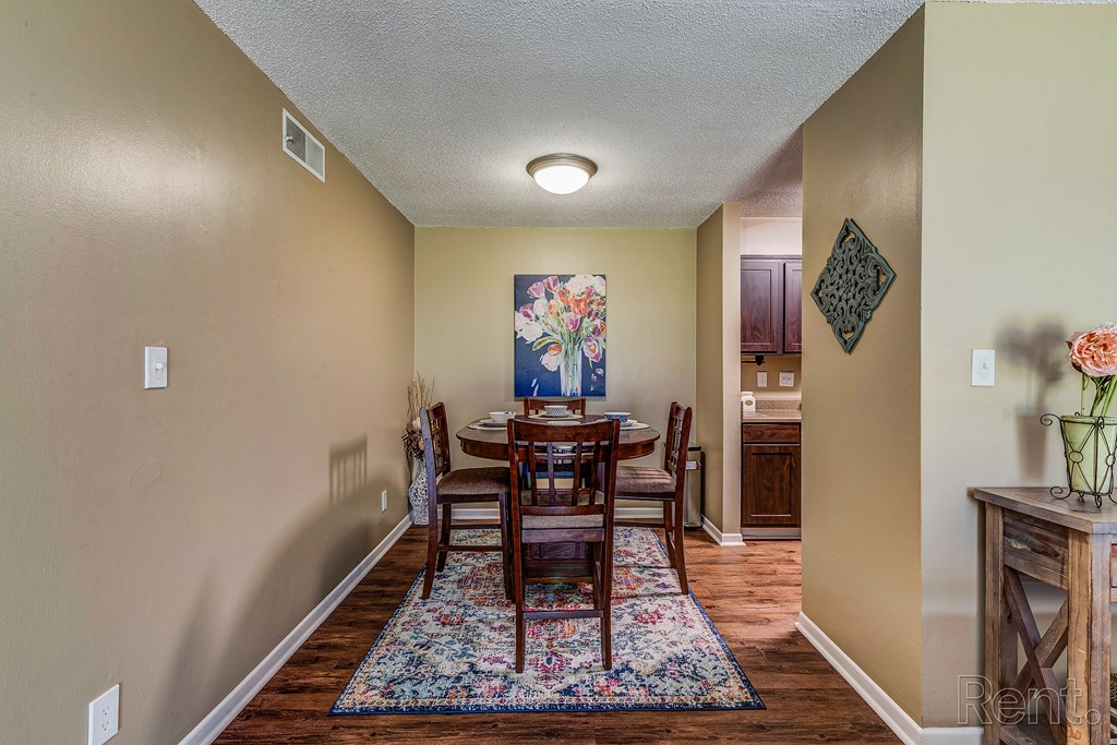 a dining room with a table and chairs and a kitchen