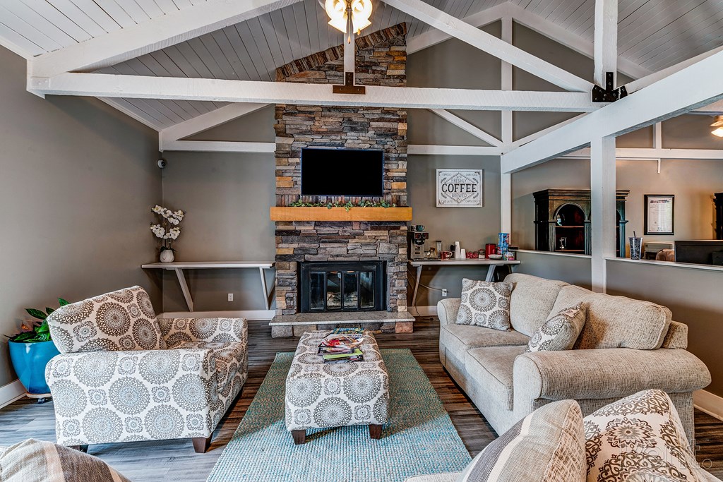a living room with couches and chairs and a fireplace
