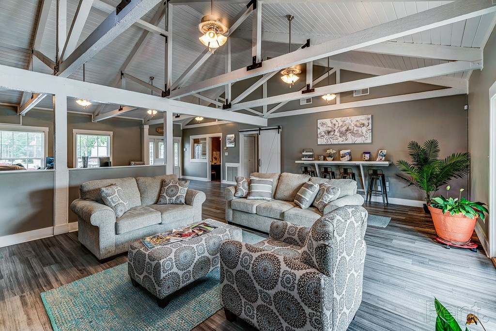 a living room with couches and chairs and a table