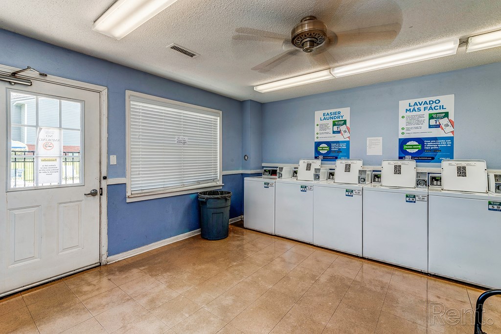 the laundry room is equipped with washers and dryers and the door is open