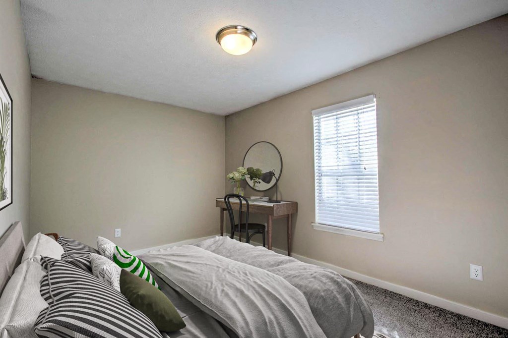 an empty bedroom with a bed and a window