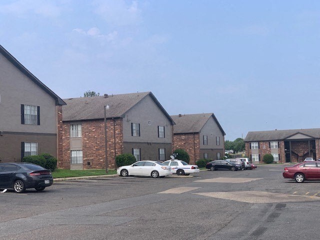 a parking lot in front of an apartment complex