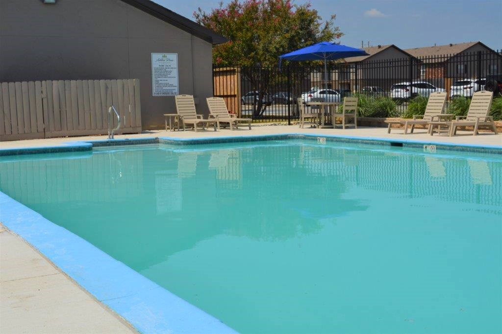 A pool with a blue border and a sign on the wall.
