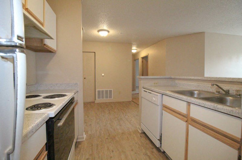 a kitchen with a stove a sink and a refrigerator