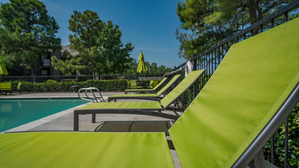 a group chairs next to a swimming pool