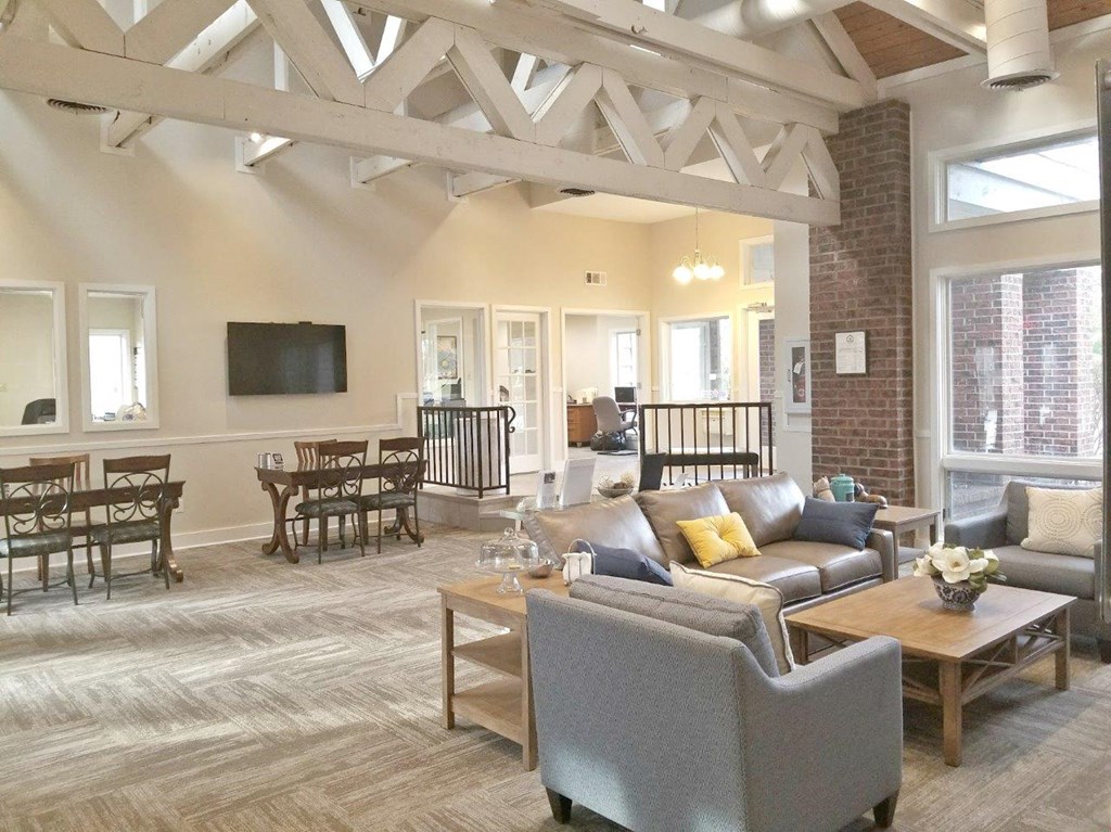 A living room with a grey sofa and a wooden coffee table.
