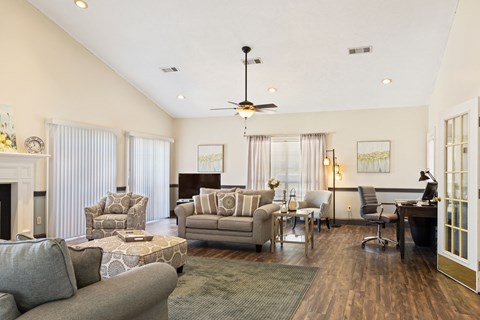 a living room with couches and chairs and a piano