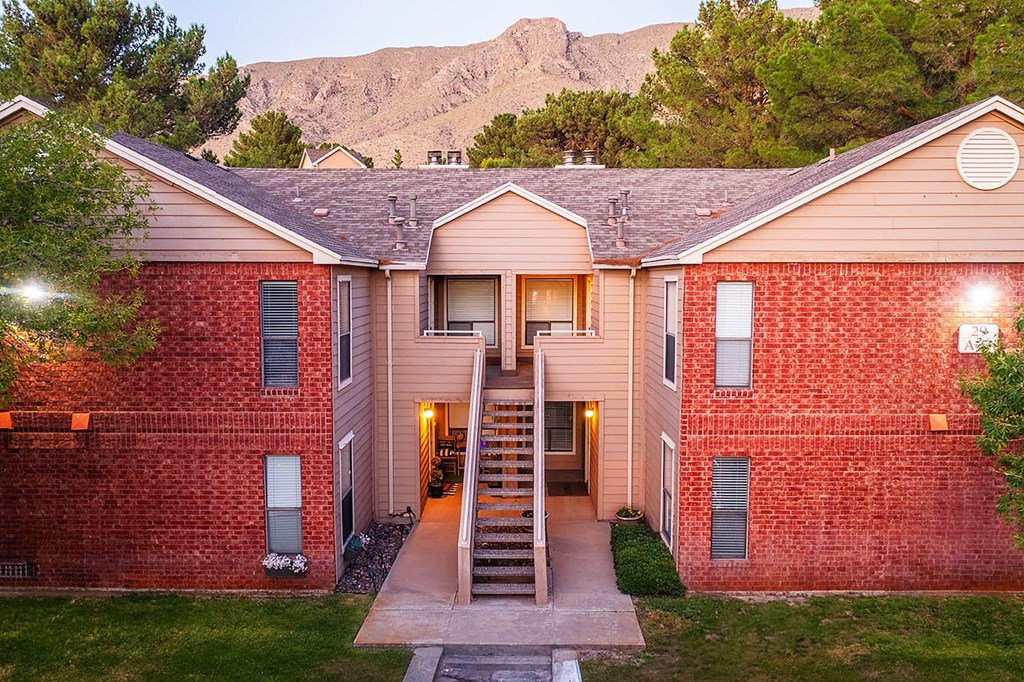 A house with a red brick exterior and a wooden roof.