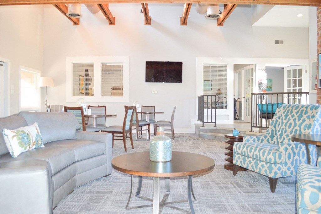 a living room with couches and chairs and a table