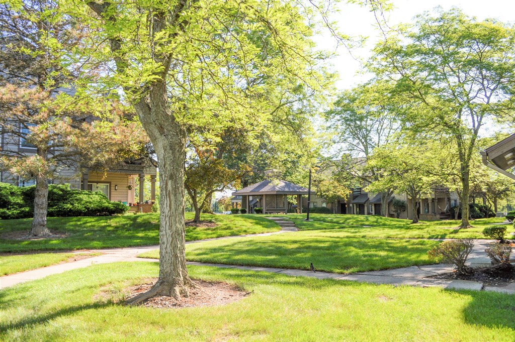 the neighborhood is full of green trees and houses
