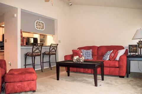 a living room with a red couch and a table