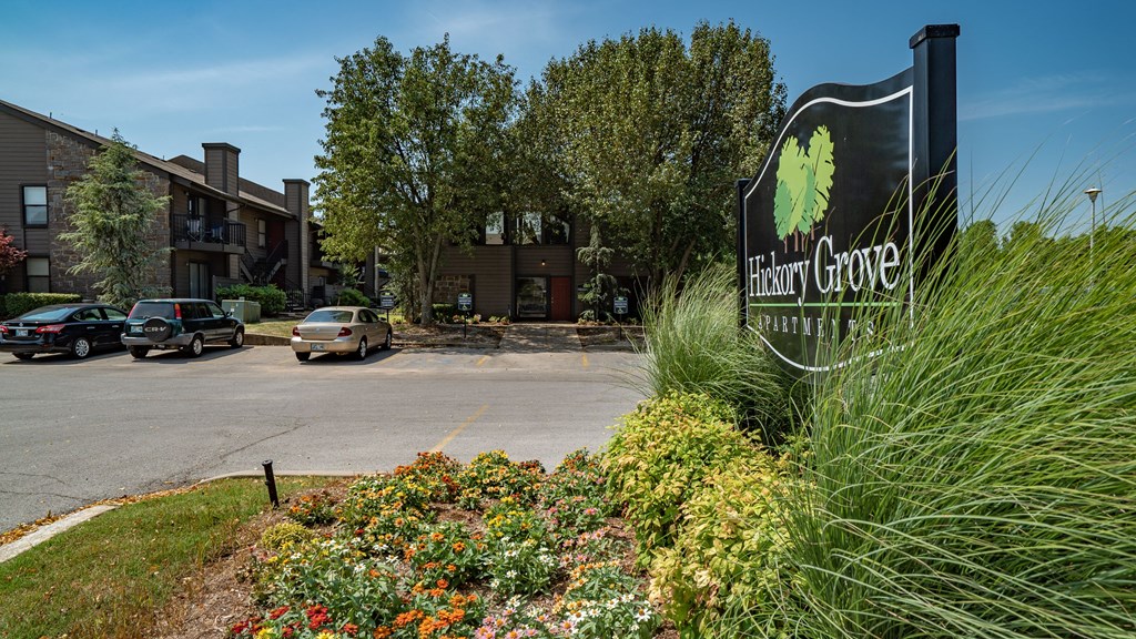 a building with a sign in front of a parking lot