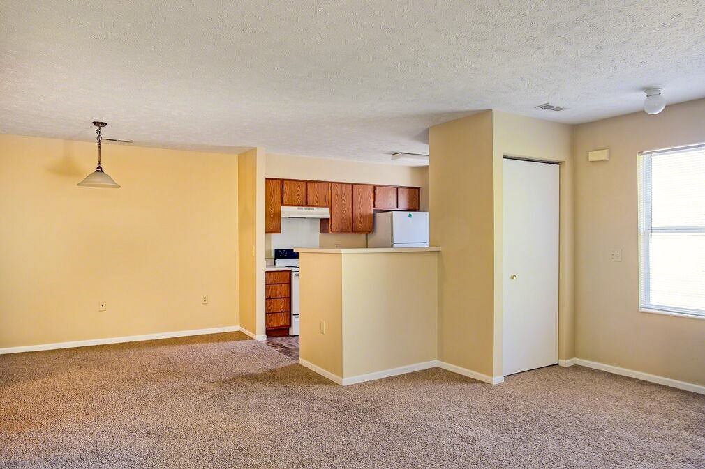 A room with a carpeted floor and a white ceiling.