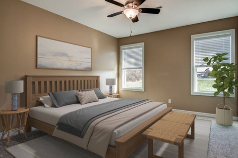 A bedroom with a bed, two lamps, a painting, and a ceiling fan.