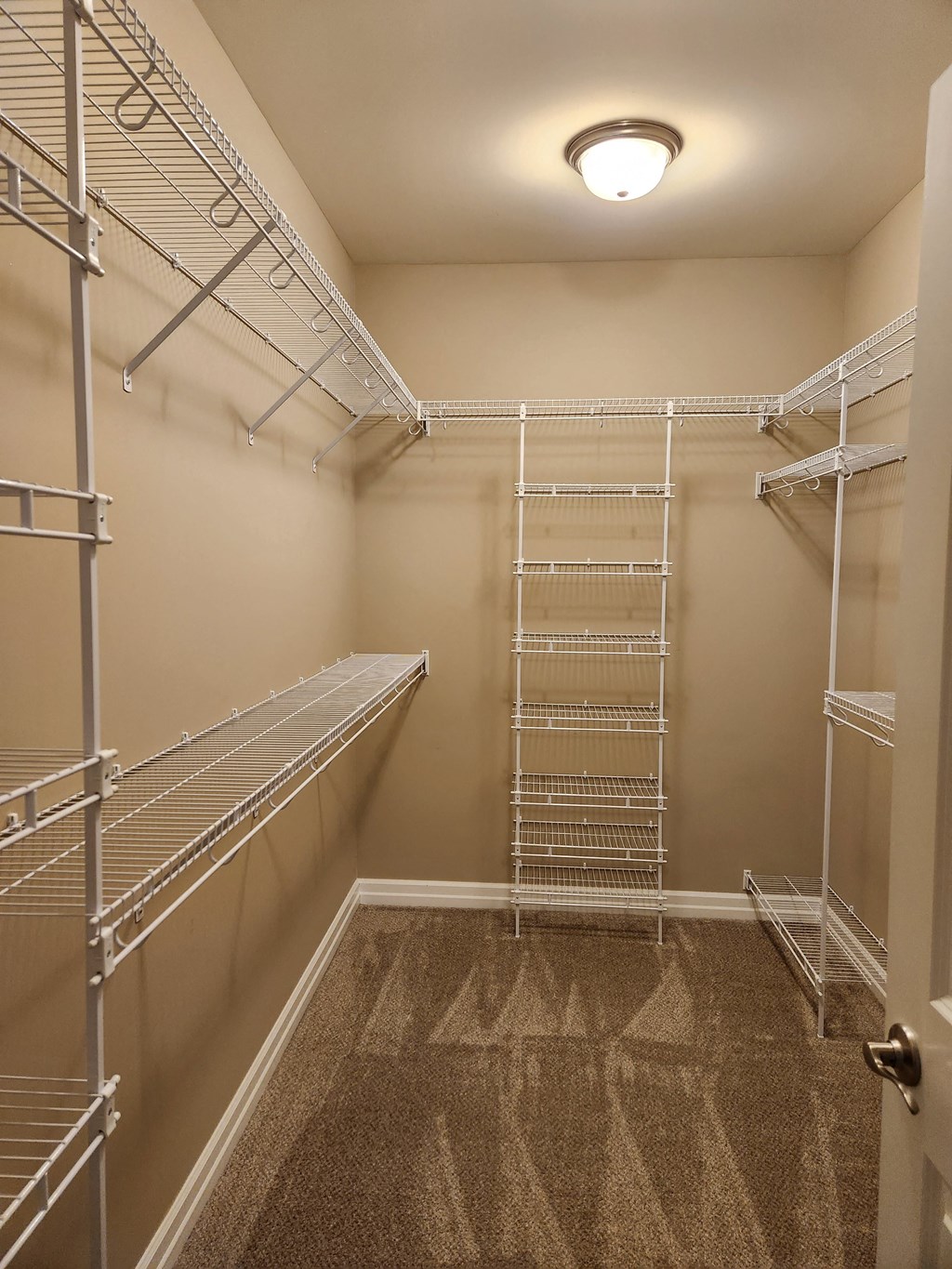 a large walk in closet with empty shelves