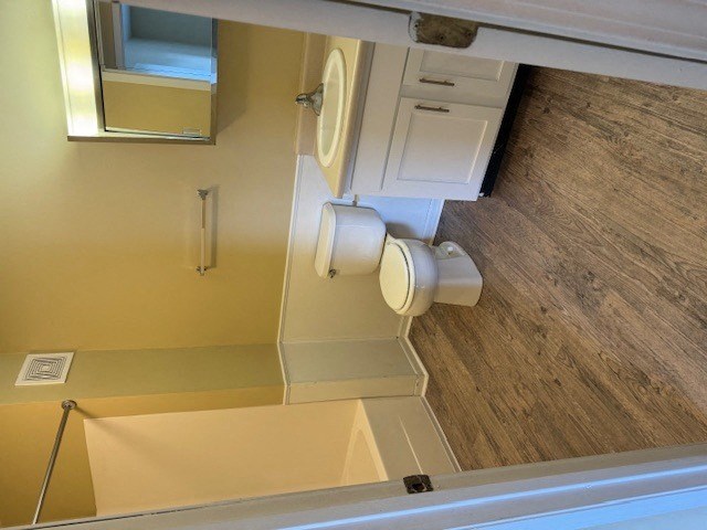 a bathroom with a toilet and a mirror