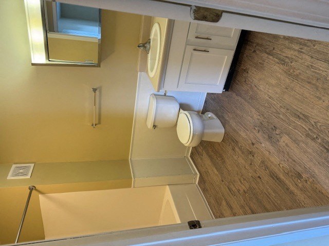 a bathroom with a mirror and two rolls of toilet paper