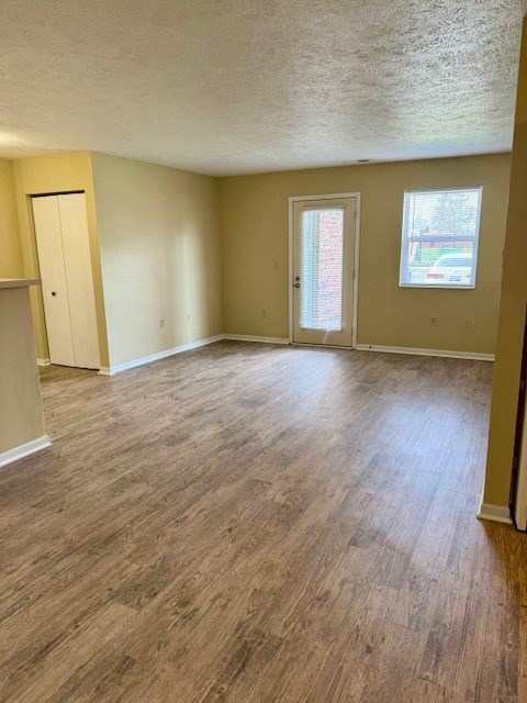 an empty living room with a hard wood floor