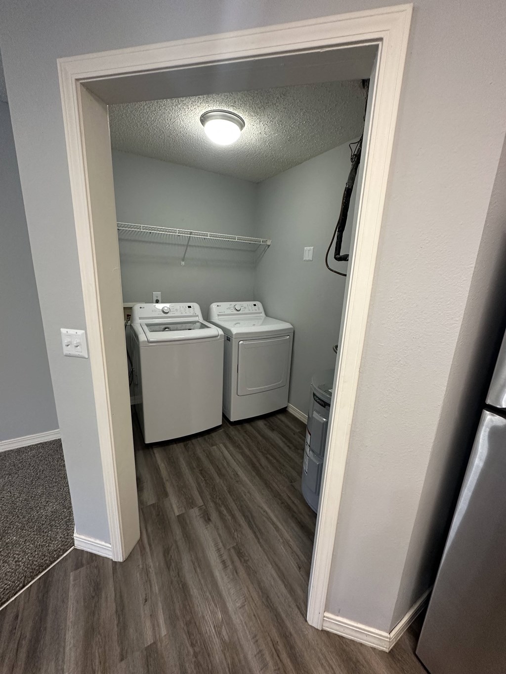 a bedroom with a washer and dryer in a room